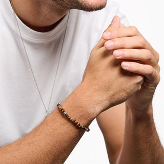Thomas Sabo stretch bracelet featuring polished brown tiger’s eye beads and ornate blackened 925 sterling silver accents.