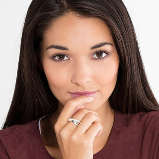 Thomas Sabo intertwined 925 Sterling silver ring with white zirconia pavé worn on a woman's finger.