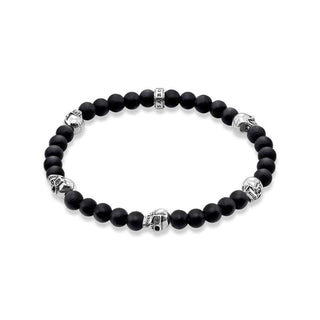 Thomas Sabo beaded bracelet in matte black obsidian with sterling silver skull accents and branded logo bead.